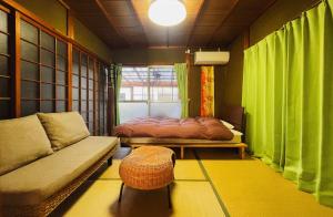 a living room with a couch and a window at Stay at matcha fields in Wazuka