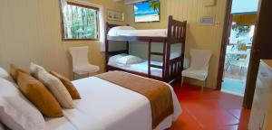 ein Schlafzimmer mit zwei Betten und einem Etagenbett in der Unterkunft Casa Gloria con Piscina - Jacuzzi exterior climatizada Relax Playa in Punta del Este + 26 Fotos