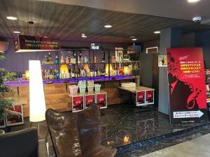 a restaurant with a bar with a counter and a chair at Hotel LAGNA in Moriyama