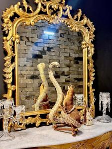 a gold mirror with a stuffed animal in front of it at Winter CBD retreat,Fireplace,Free secure parking, Balcony, NETFLIX, FREE WIFI, Walk to Rundle St, UniAdelaide, Casino, Pubs, Cafes in Adelaide +16 photos