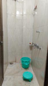 a bathroom with a shower with a blue bowl at Parinuj homestay in Chittaurgarh
