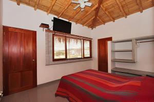 a bedroom with a bed and a flat screen tv at Casa Arena y Mar in Los Órganos +36 photos