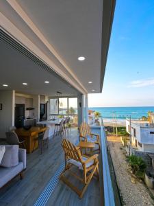 an open living room with a view of the ocean at Brand New!! Cozy Beachfront Apartment in Punta Blanca +53 photos