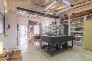 a large room with a kitchen with a stove in it at Casa Azul Tropical House by Xarm Apartments in Santa Marta