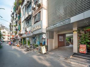 a street with buildings and bikes parked on the street at Minerva Aparthotel Hanoi in Hanoi