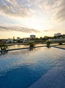 a large swimming pool with a city in the background at Brand New!! Cozy Beachfront Apartment in Punta Blanca