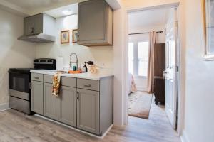 een keuken met grijze kasten en een wastafel bij Mariposa Coral Home for 4 in Kerrville +10 foto's