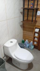 a white toilet in a bathroom with a staircase at Los Sosa y Más in Santa Vitória do Palmar +16 photos
