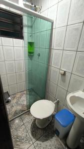 a bathroom with a shower and a toilet and a sink at Sobrado há 7 quadras da praia in Matinhos +11 photos