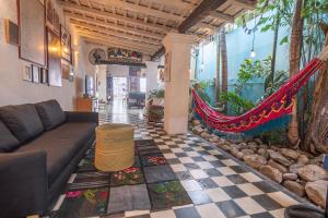 a living room with a couch and a hammock at Casa Azul Tropical House by Xarm Apartments in Santa Marta