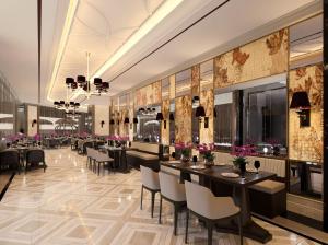 a restaurant with tables and chairs and flowers on the walls at Trans Hotel Jakarta in Cibubur