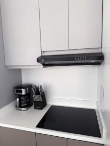 a kitchen with a sink and a microwave at Brand New!! Cozy Beachfront Apartment in Punta Blanca