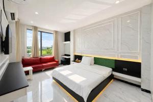 a bedroom with a bed and a red couch at 168 Hotel in Ho Chi Minh City