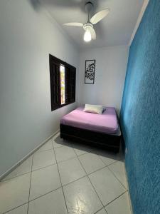 une chambre avec un lit dans une pièce avec une fenêtre dans l'établissement Pousada Preziosa Beach Itanhaém, à Itanhaém