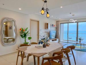 a dining room with a table and chairs and a mirror at Sea Blooming - The Sóng Vũng Tàu - Gần Biển, Miễn Phí Hồ Bơi, Sauna, Gym in Vung Tau +109 photos