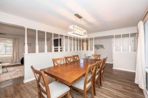 a dining room with a wooden table and chairs at The Terrace Timber House For 8 in Hamilton