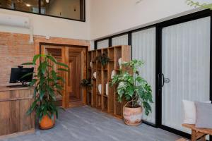 a patio with two potted plants and a door at The Tribe Nimman Boutique Hotel in Chiang Mai +64 photos