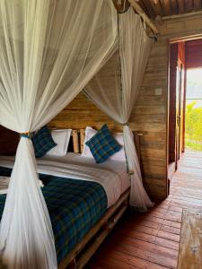 a bedroom with a bed with a canopy at Nyanja View Resort in Fort Portal