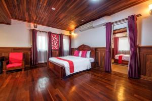 a bedroom with a bed and a chair in it at SATTA Private Pool Grill & Chill Villa in Siem Reap