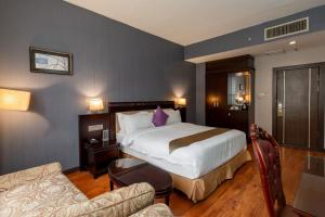 una habitación de hotel con una cama y un sofá en Kingston Hotel 18 - Kuala Lumpur Sri Damansara, en Kuala Lumpur 41 fotos más