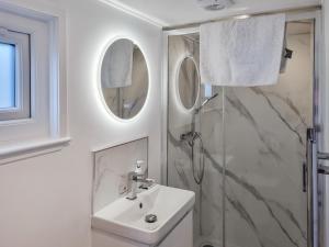 a white bathroom with a sink and a shower at Tyan - Uk49354 in Gatebeck +2 photos