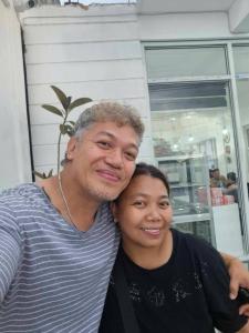a man and a woman posing for a picture at Ma Fremie Hometel in Lal-lo