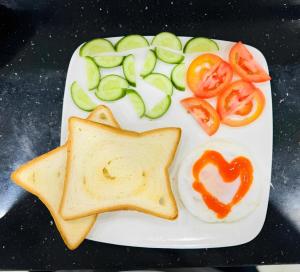 a plate of food with toast and vegetables on it at Tam Coc Michoc Homestay in Ninh Binh