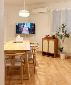 a dining room with a table and a tv at Spacious 2BR Apartment near Subway Free Parking Seoul in Seoul