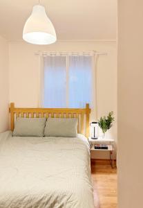 a bedroom with a bed and a window at Spacious 2BR Apartment near Subway Free Parking Seoul in Seoul
