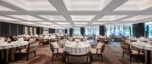 a banquet hall with white tables and chairs at The Lakeview Hotel in Beijing