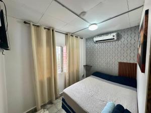 ein kleines Schlafzimmer mit einem Bett und einem Fenster in der Unterkunft Apartment in downtown David in David