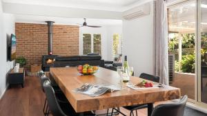 a dining room with a table and chairs and a fireplace at La Playa in Myola