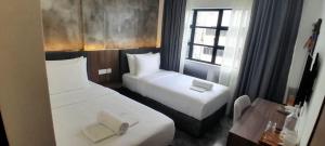 Postel nebo postele na pokoji v ubytování Muari Boutique Hotel