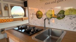 a kitchen with a sink and a counter top at Hausboot in Berlin, festliegend im Yachthafen Schmöckwitz, mit Heizung in Berlin