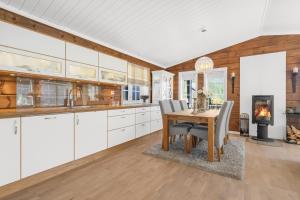 a kitchen with a table and chairs and a fireplace at Luxury cabin with amazing views in Stryn