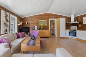 a living room with a couch and a table at Luxury cabin with amazing views in Stryn +24 photos