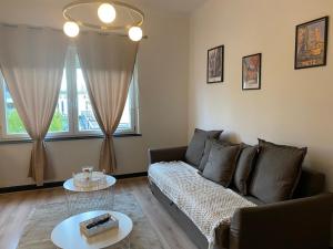 a living room with a couch and a table at Le Saint Symphorien 4 in Longeville-lès-Metz +2 photos