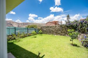 a garden with a stone fence and flowers at Rural Retreat with Charming Patio 2 Bedrooms in Urubamba