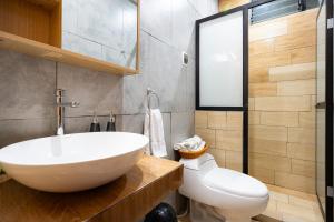 a bathroom with a white sink and a toilet at Rural Retreat with Charming Patio 2 Bedrooms in Urubamba +28 photos