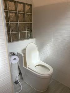 a bathroom with a toilet with the lid up at Palacios Residences in Iloilo City +3 photos