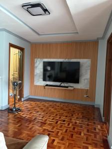 a living room with a flat screen tv on a wall at Palacios Residences in Iloilo City
