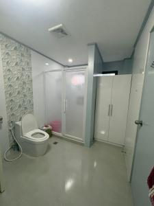 a bathroom with a toilet and a shower at Palacios Residences in Iloilo City