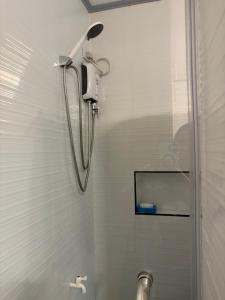 a shower with a shower head in a bathroom at Palacios Residences in Iloilo City