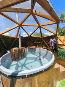 una vasca idromassaggio in un edificio in legno con tetto di domos anmile a Los Quillayes Altre 15 foto
