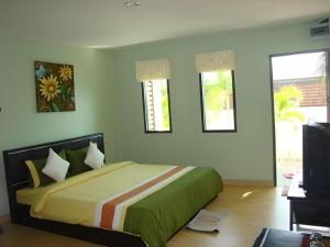 a bedroom with a bed and a tv and windows at Sea Beach Koh Larn 1 in Ko Larn +137 photos