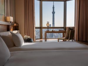 a bedroom with a bed with a view of the eiffel tower at Asakusa View Hotel in Tokyo