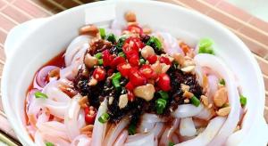 a white bowl of food with noodles and vegetables at Mount Emei Fulin Hotel in Baoguosi