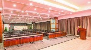 a large room with rows of chairs and a podium at Lavande Hotel Yichang Railway East Station Branch in Yichang