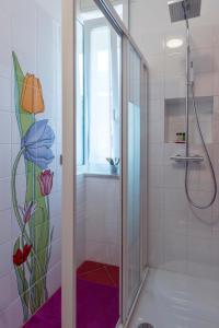 a shower with a glass door in a bathroom at B&B Villa Giuli in Varese