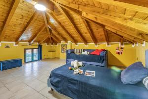 - un salon avec deux canapés bleus et des plafonds en bois dans l'établissement Villino Maria - Happy Rentals, à Angera